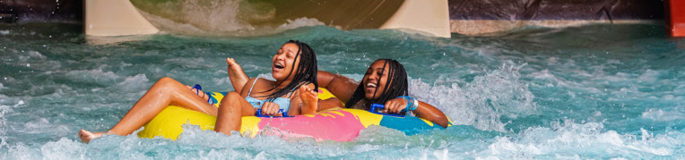 Two women on an inner tube at the Ƶ Indoor WaterPark